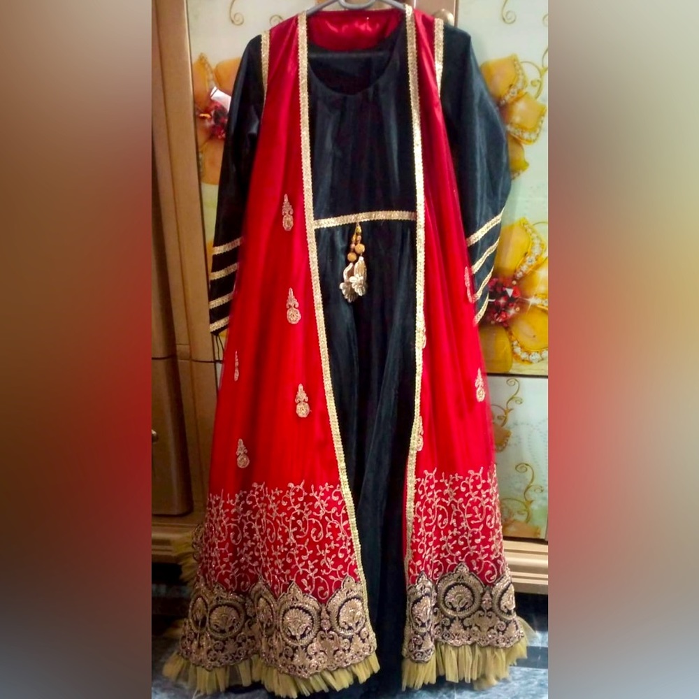 Black maxi with red embroidered jacket and trouser. Black net dupatta